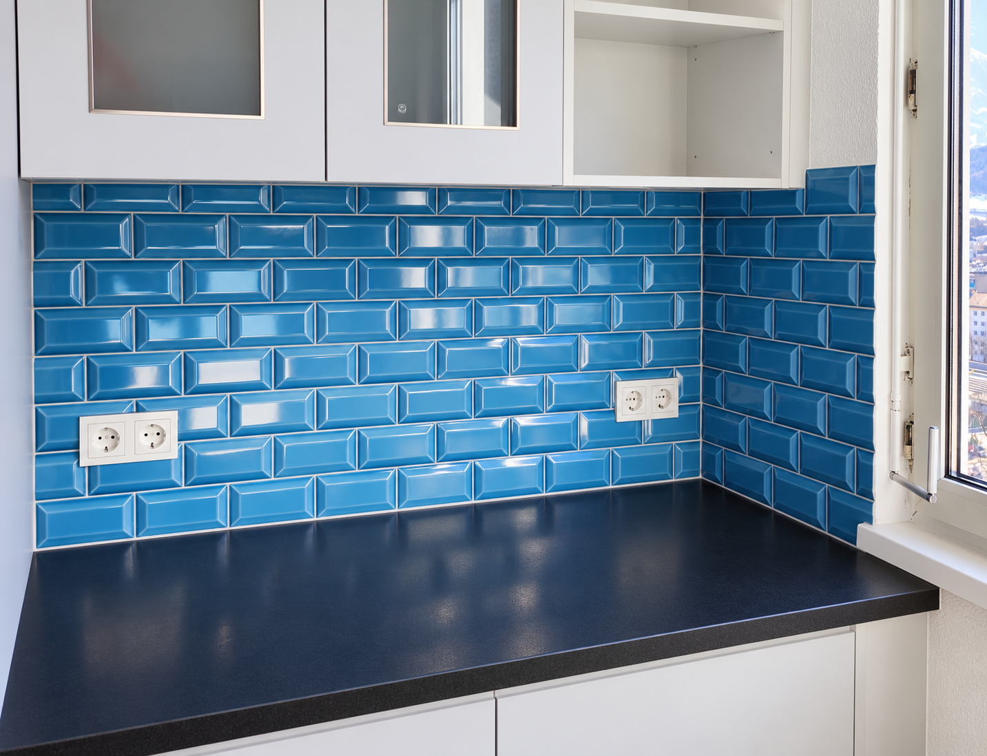 Blue beveled subway tile kitchen backsplash