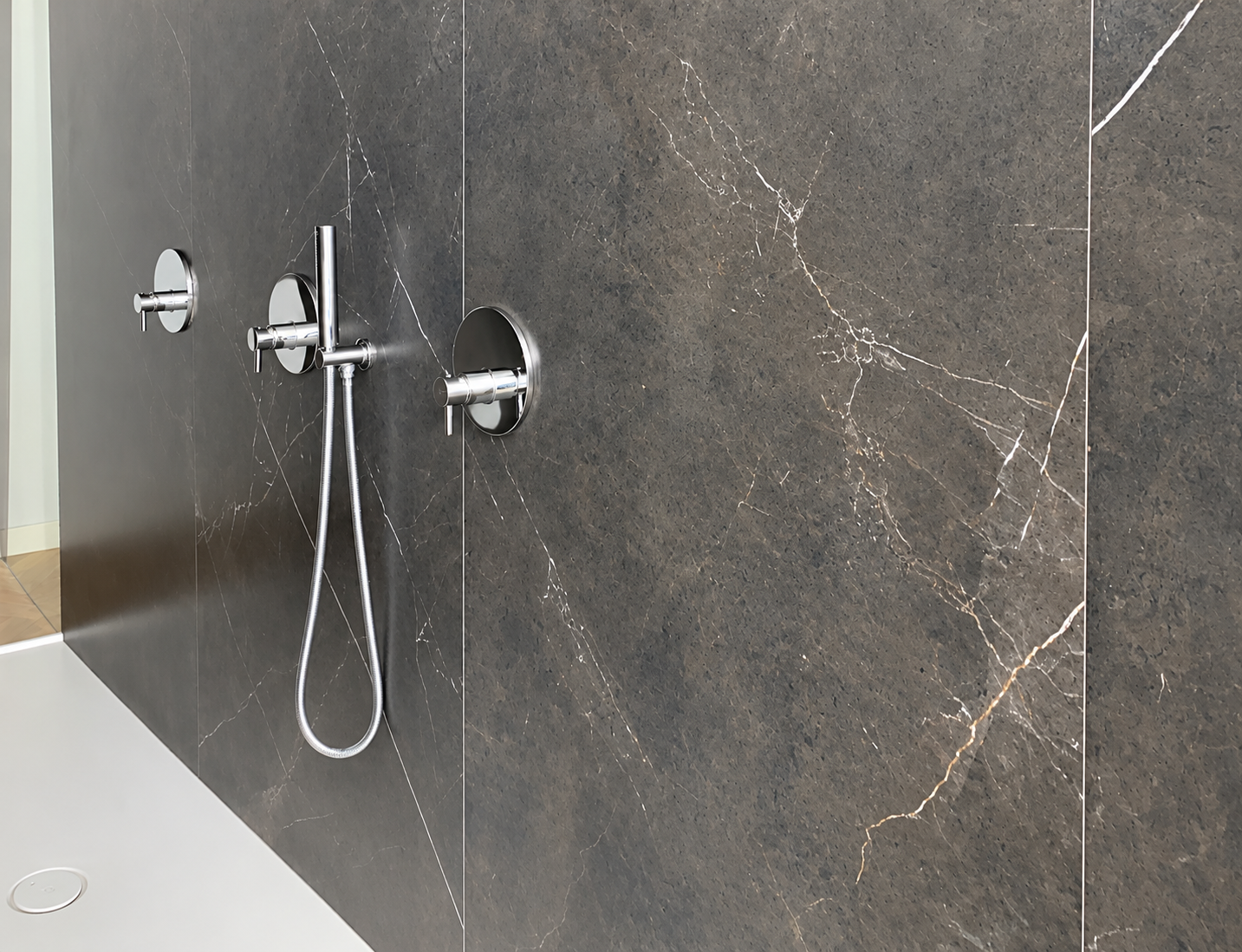 Charcoal stone shower with chrome fixtures