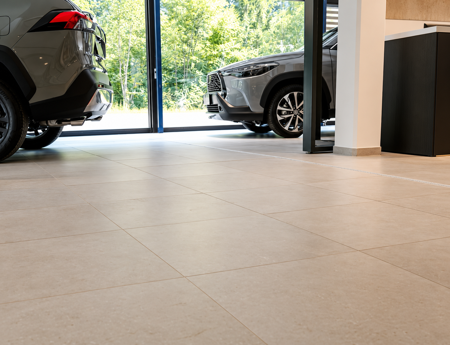 Daylit greige tile showroom with cars