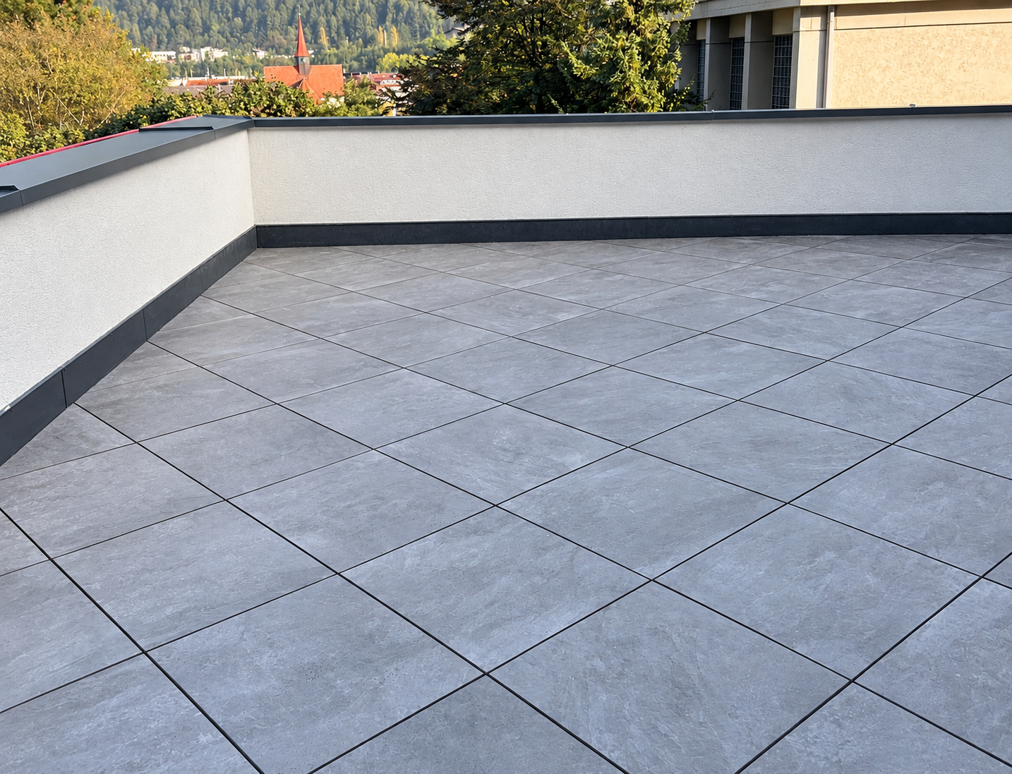 Gray tile terrace with white parapet