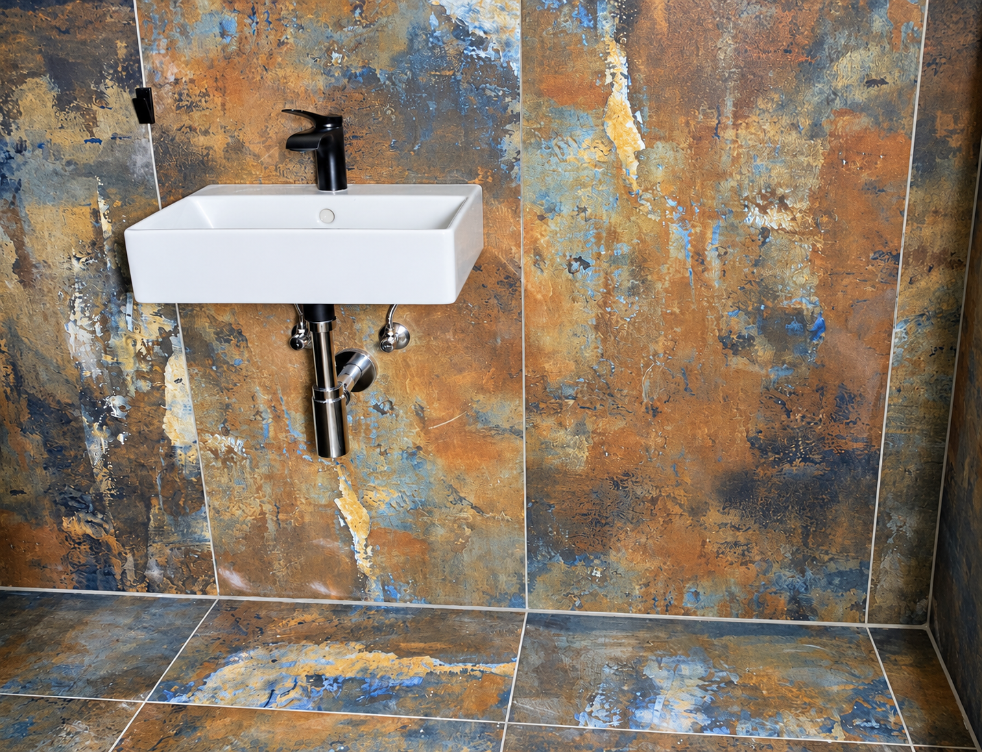 Oxidized-metal-look tiles with white basin