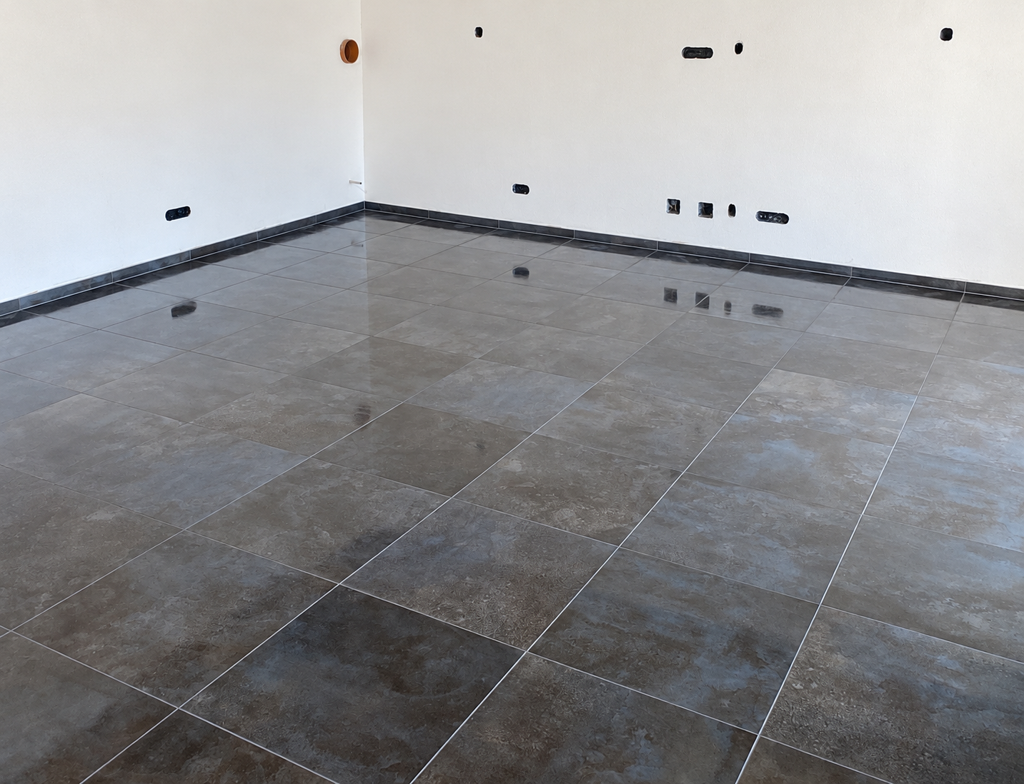 Polished charcoal tile floor installation