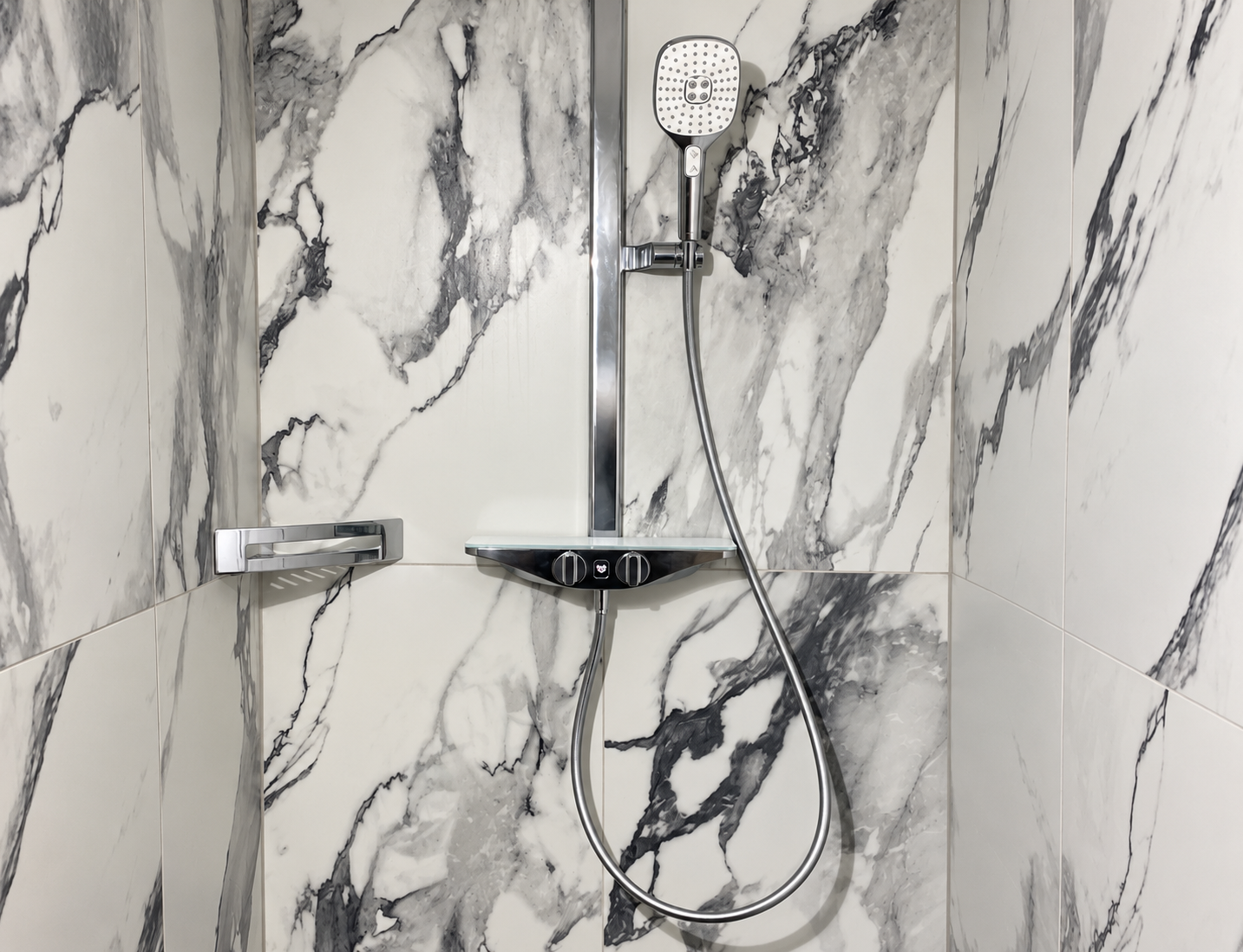 Refined marble shower with chrome fixtures