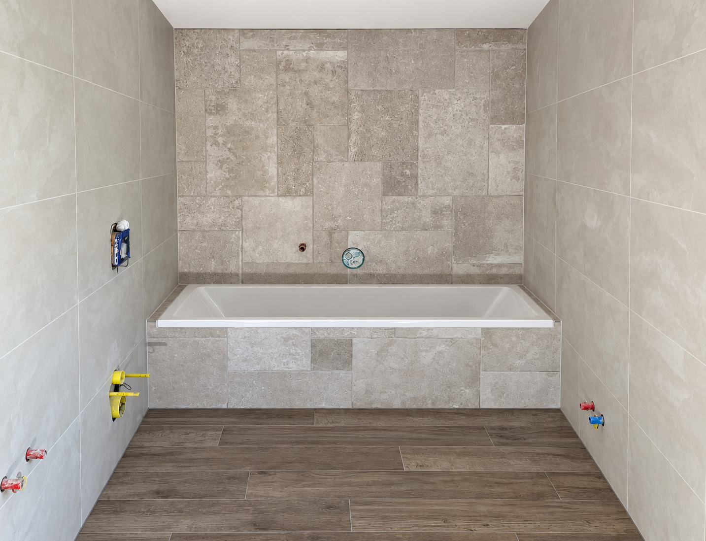 Stone-tiled bathroom with inset bath