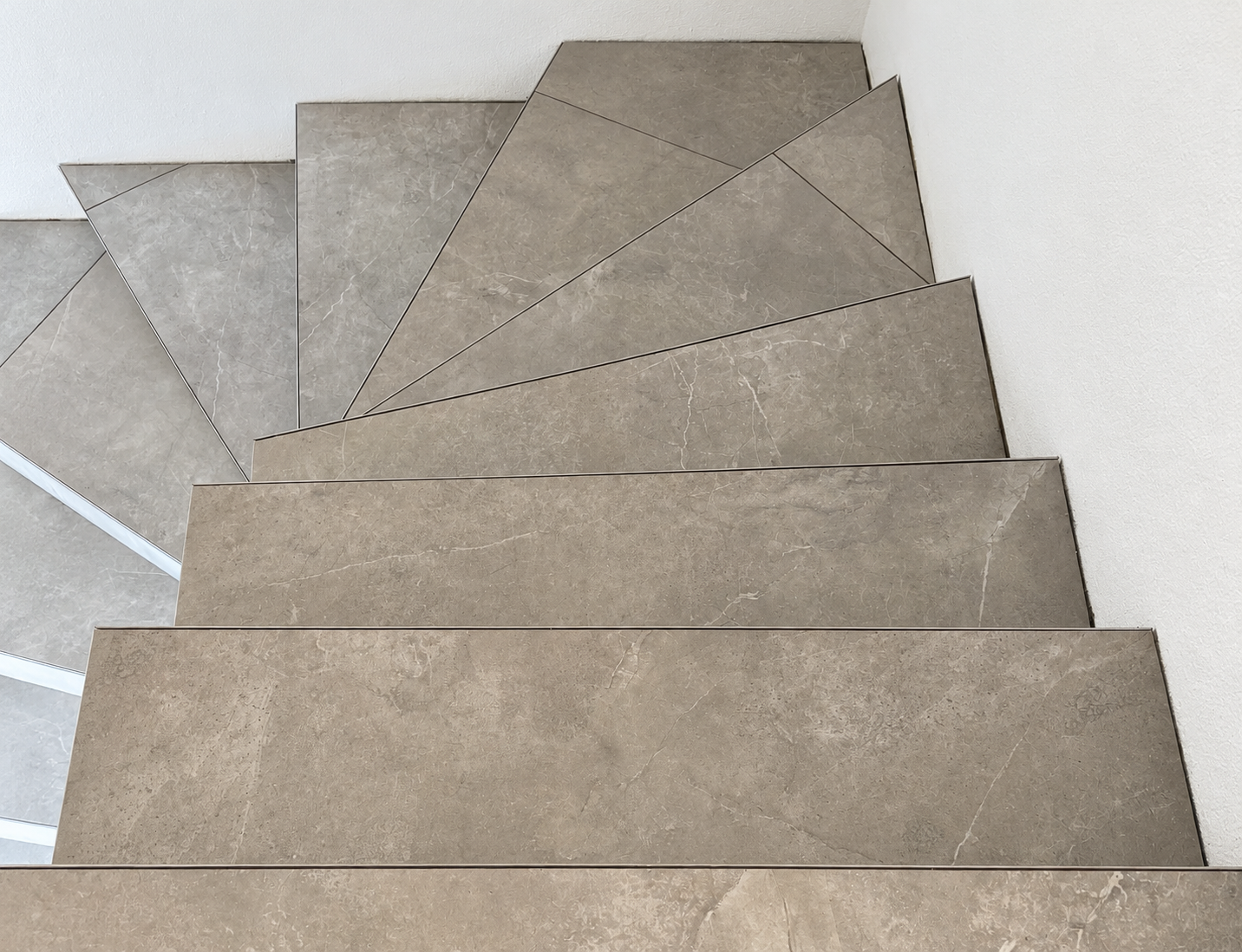 Warm gray tiled winding staircase
