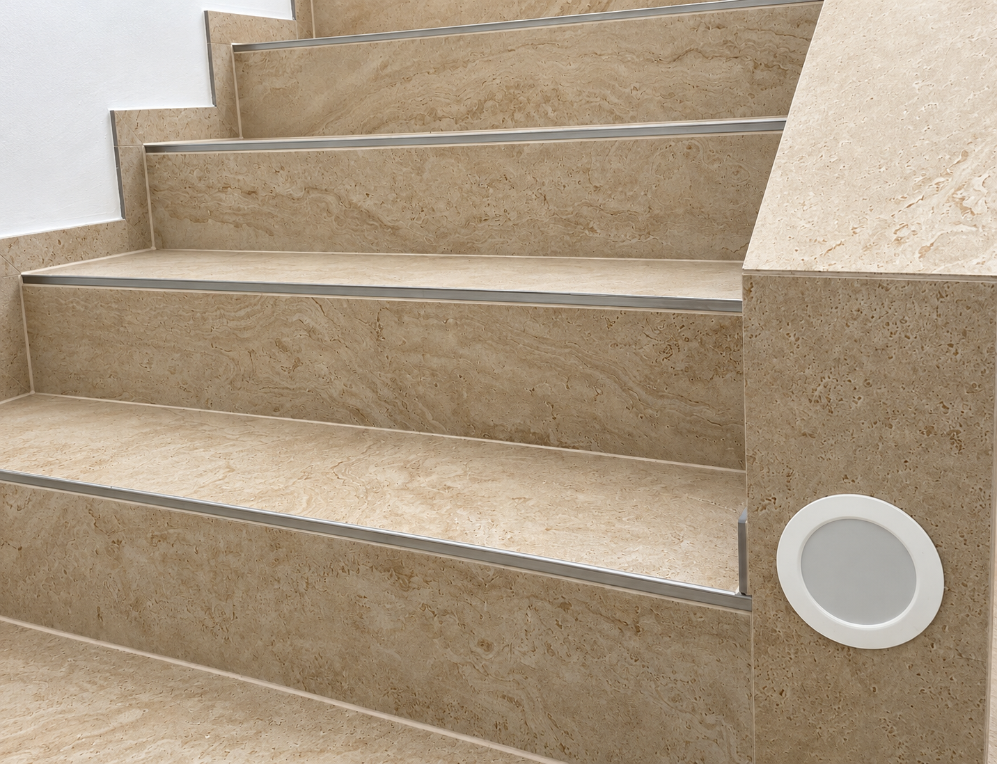 Warm stone staircase with integrated round light