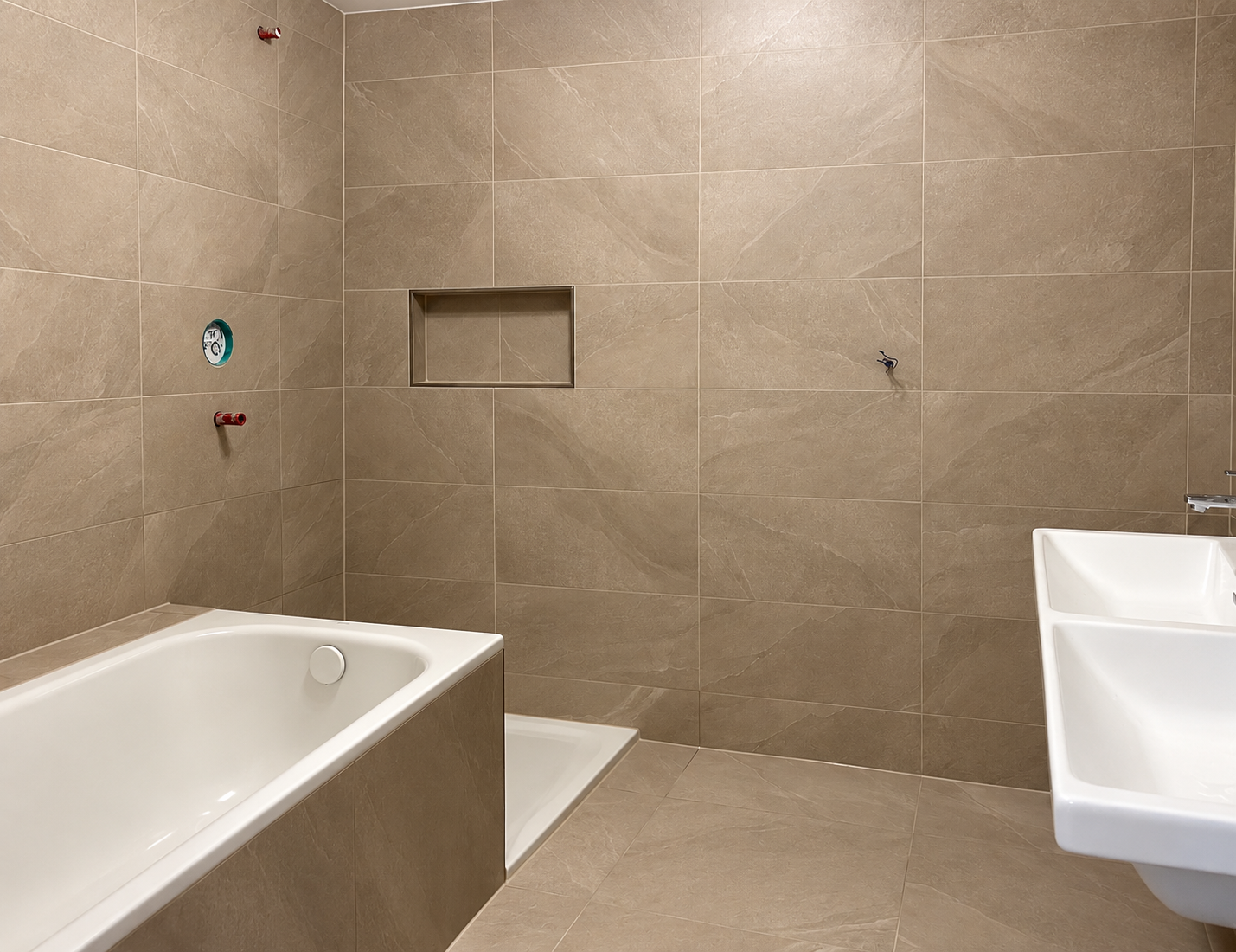 Warm taupe tiled bathroom with bathtub